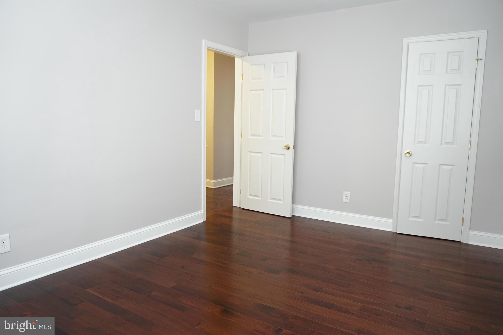 901 Wicklow Road Baltimore, MD 21229 - Photo 23 of 29 a view of an empty room with wooden floor