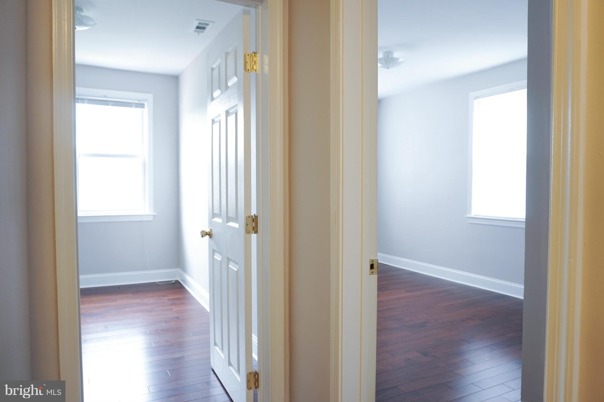 901 Wicklow Road Baltimore, MD 21229 - Photo 26 of 29 a view of an empty room with wooden floor and a bathroom