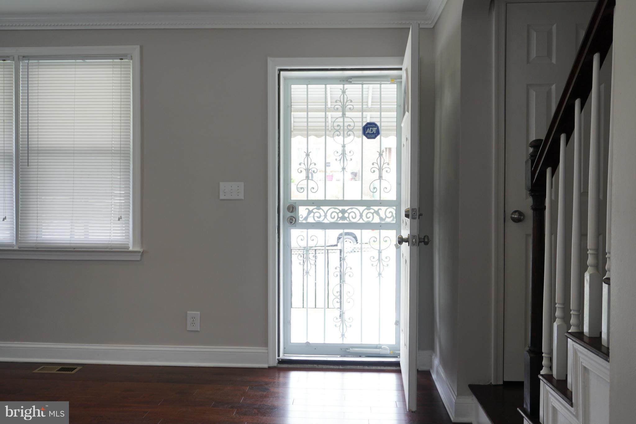 901 Wicklow Road Baltimore, MD 21229 - Photo 29 of 29 a view of an empty room with wooden floor and a window