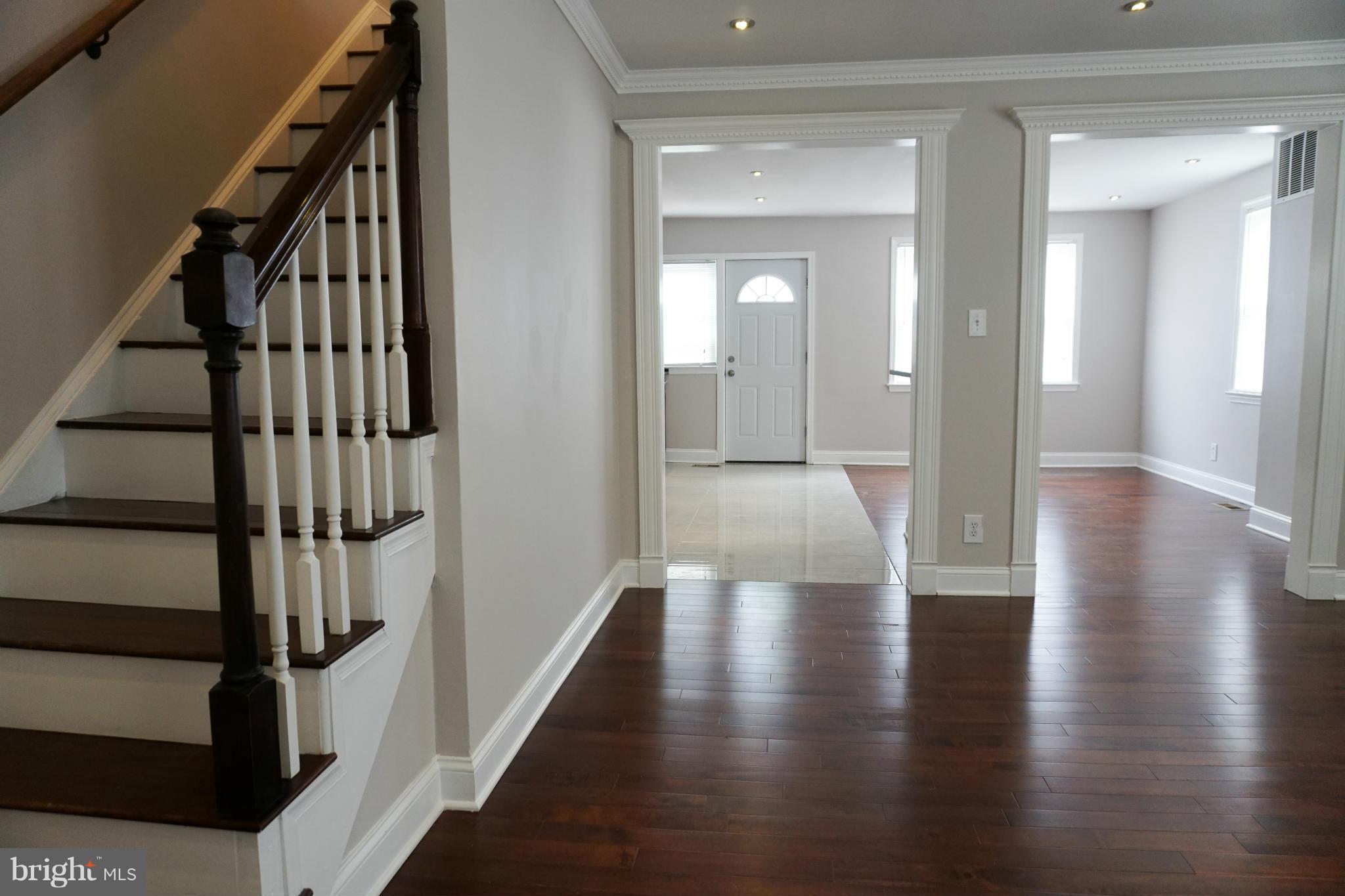 901 Wicklow Road Baltimore, MD 21229 - Photo 6 of 29 a view of a hallway with wooden floor and staircase