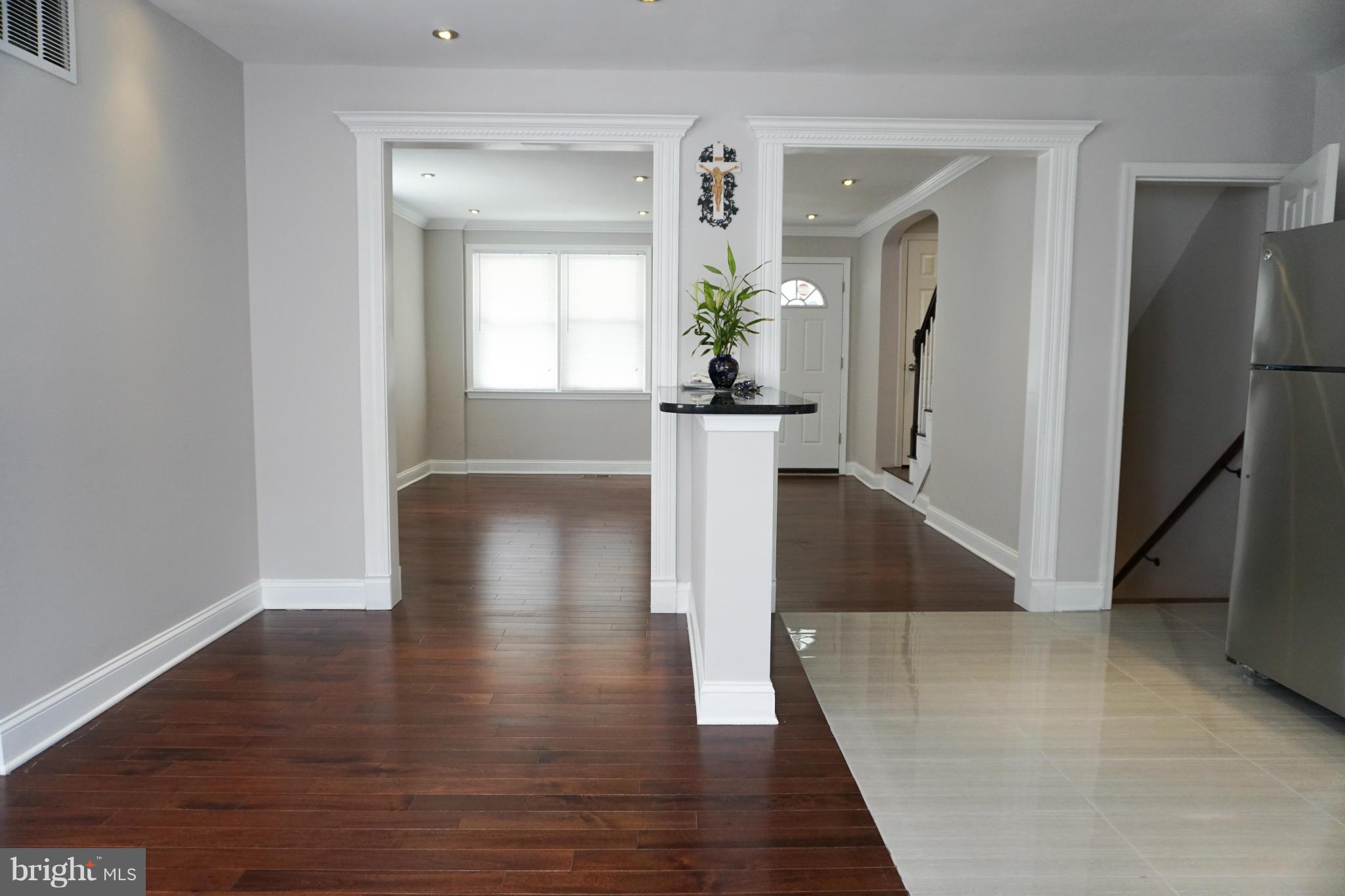 901 Wicklow Road Baltimore, MD 21229 - Photo 8 of 29 wooden floor in an empty room with a mirror