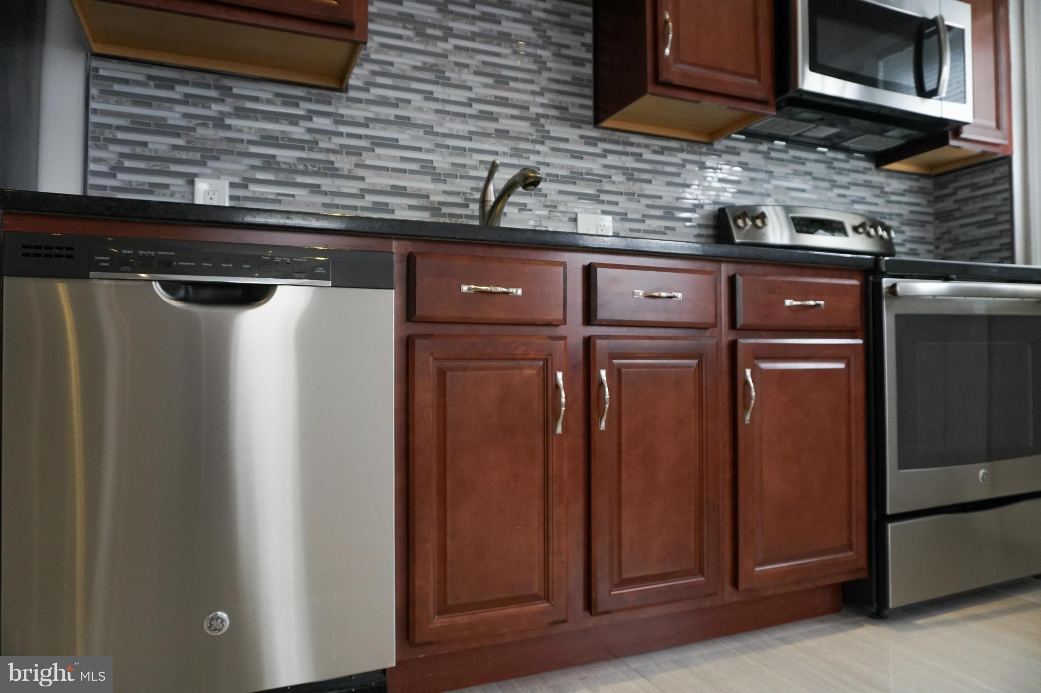 901 Wicklow Road Baltimore, MD 21229 - Photo 9 of 29 a kitchen with stainless steel appliances granite countertop a refrigerator and a sink