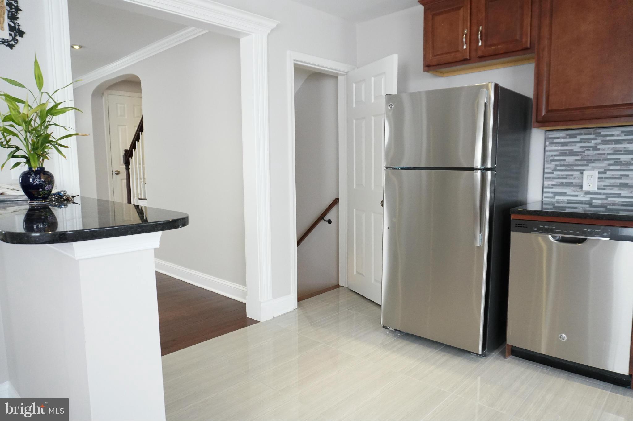 901 Wicklow Road Baltimore, MD 21229 - Photo 10 of 29 a view of a kitchen with refrigerator and white cabinets