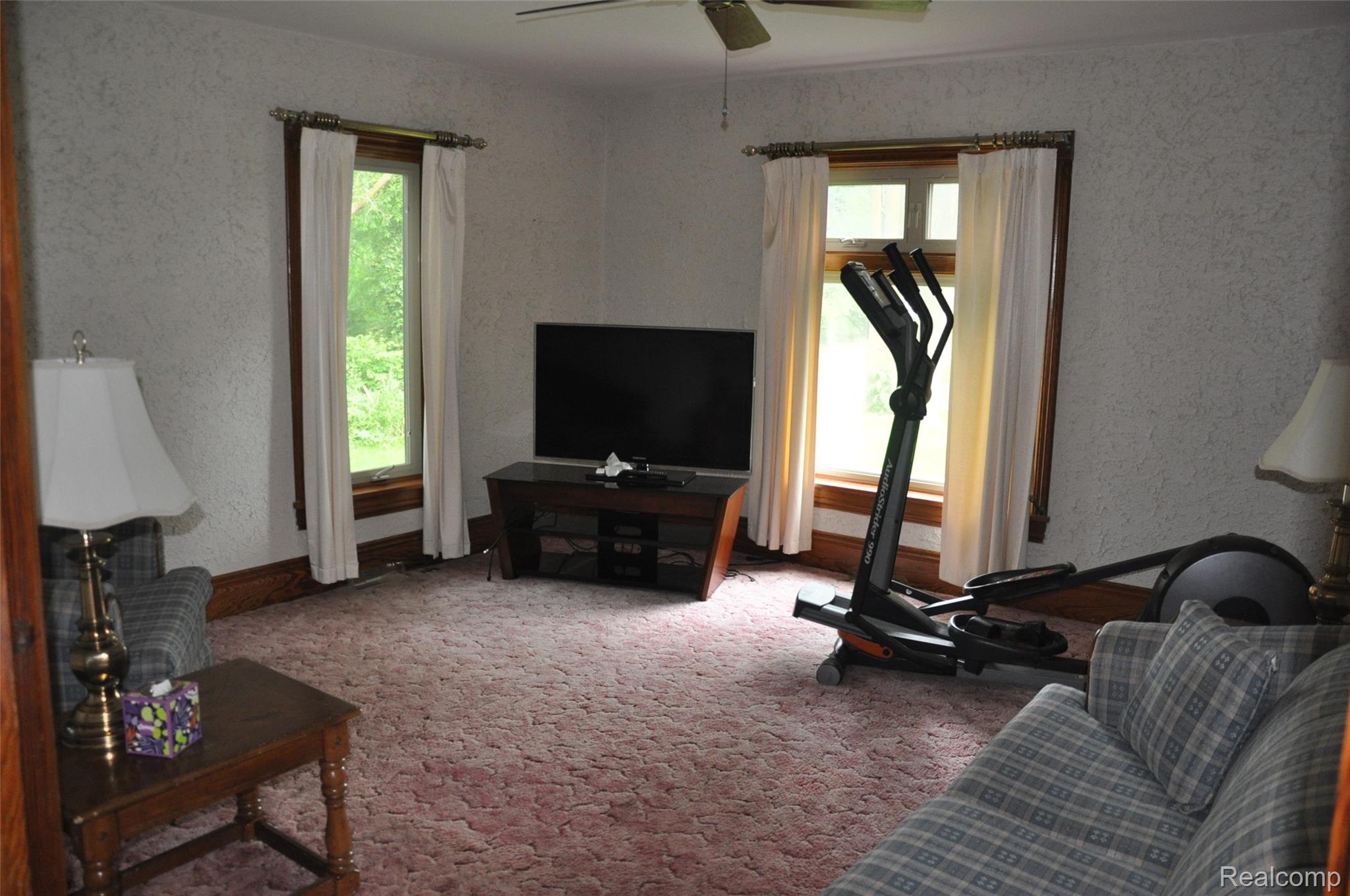 3954 Mayville Road Silverwood, MI 48760 - Photo 16 of 30 Carpeted interior space featuring two windows with wood trim