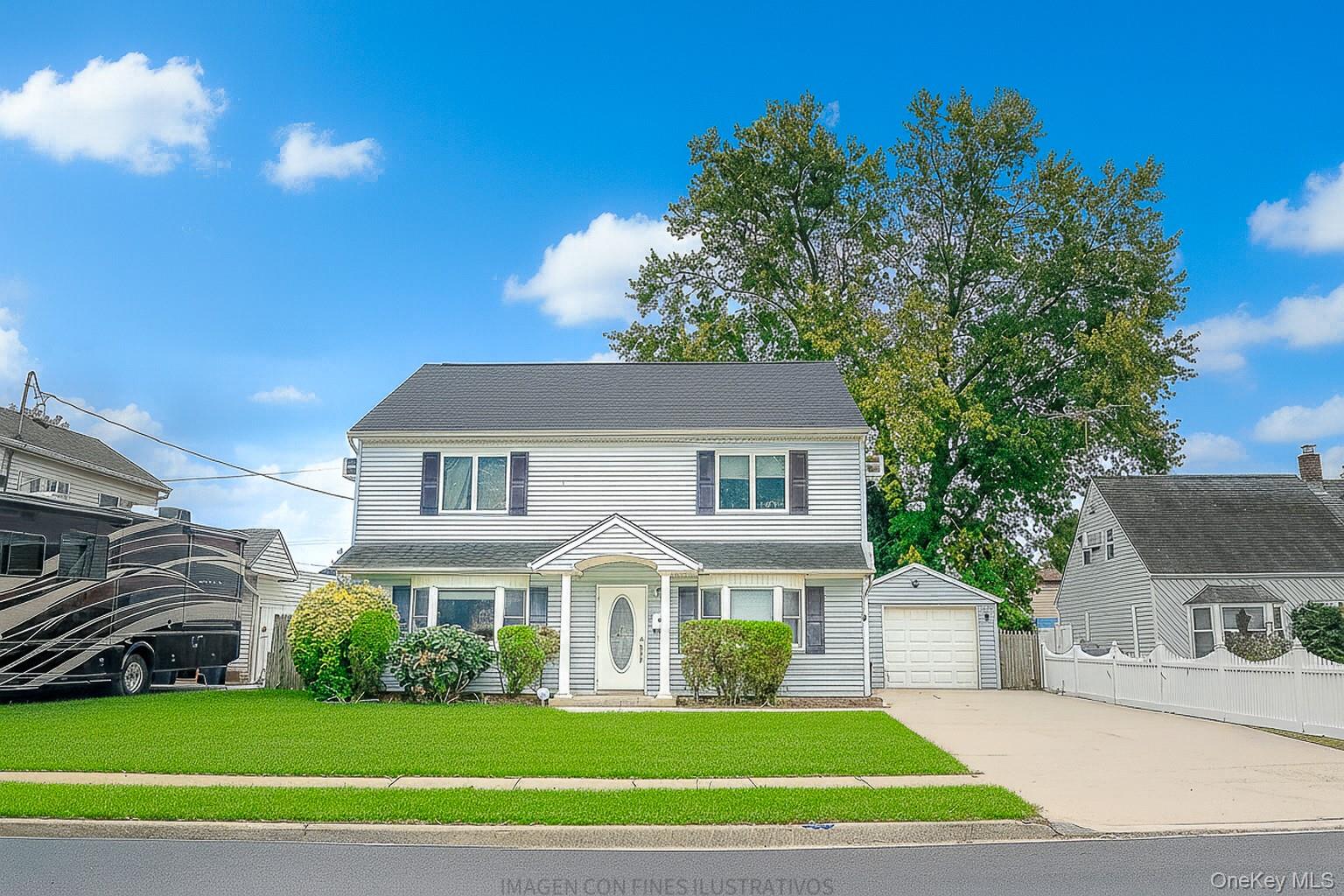 74 Old Farm Road Levittown, NY 11756 - Photo 1 of 1 a front view of a house with a garden and plants