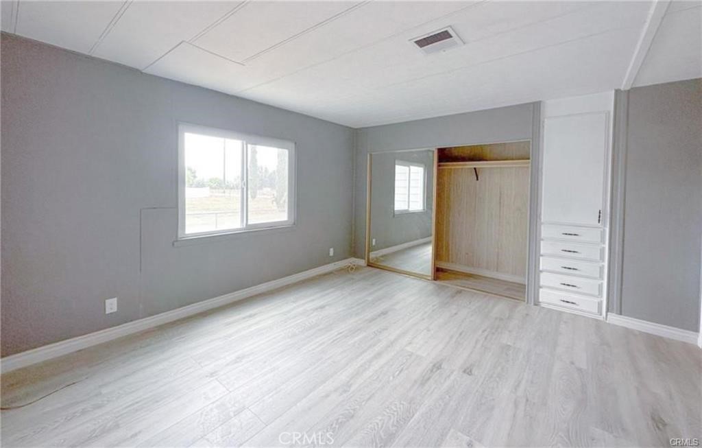 28160 Patterson Avenue Winchester, CA 92596 - Photo 11 of 57 an empty room with wooden floor and windows