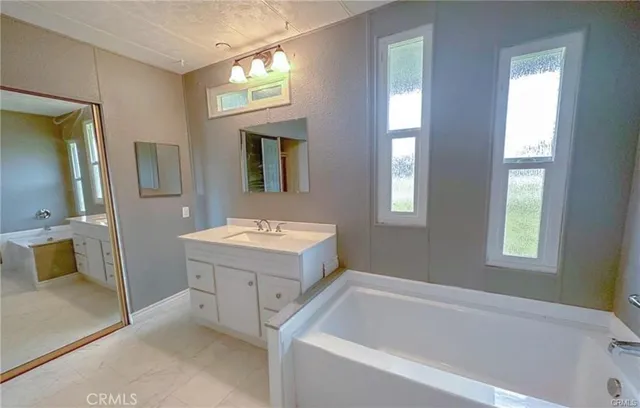 a view of an empty room with window and cabinet