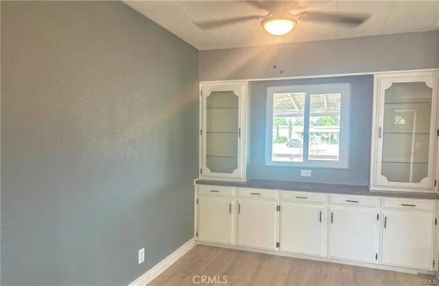 a view of an empty room and wooden floor