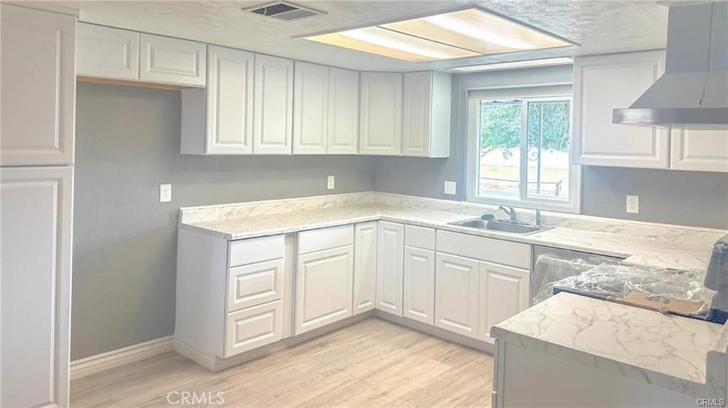 28160 Patterson Avenue Winchester, CA 92596 - Photo 19 of 57 a kitchen with granite countertop white cabinets and white appliances