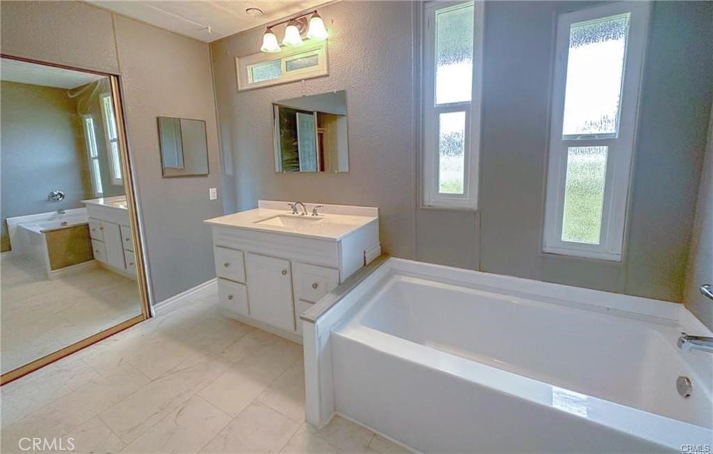 28160 Patterson Avenue Winchester, CA 92596 - Photo 2 of 57 a bathroom with a tub sink and mirror
