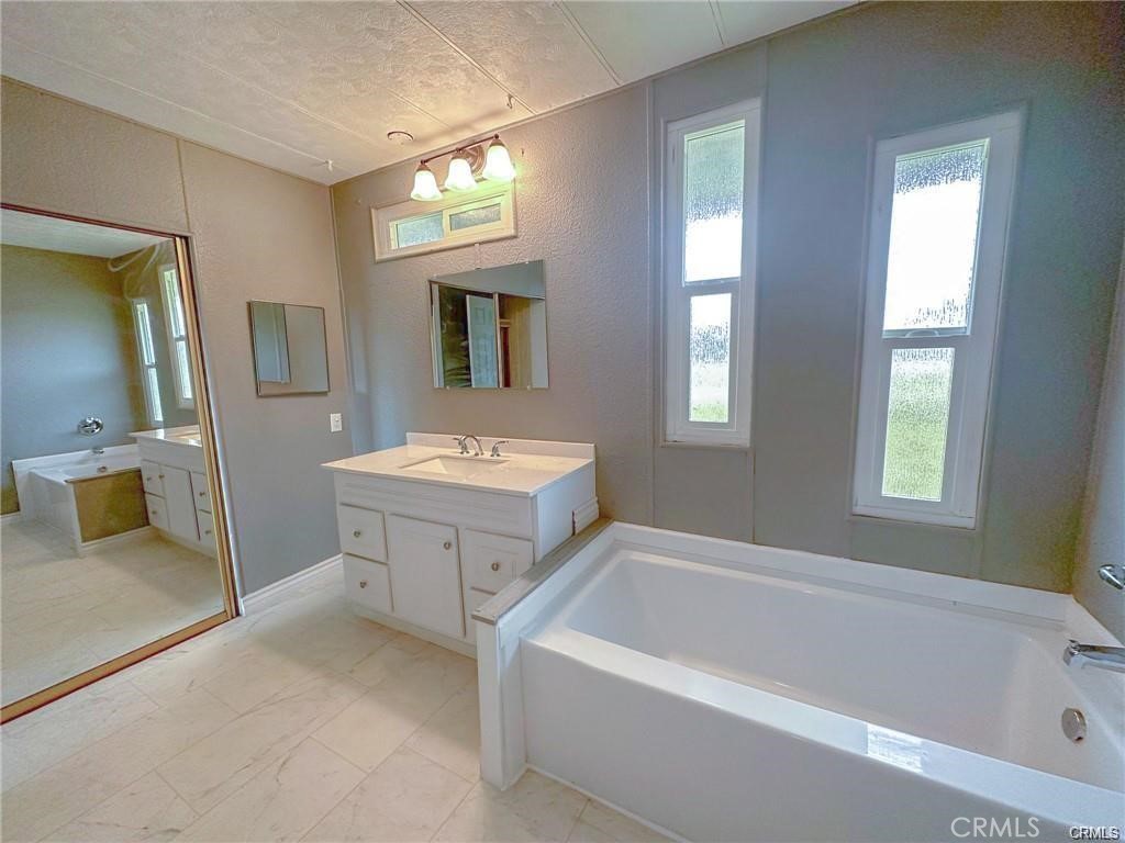 28160 Patterson Avenue Winchester, CA 92596 - Photo 26 of 57 a bathroom with a tub sink and mirror