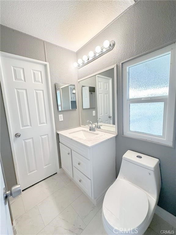 28160 Patterson Avenue Winchester, CA 92596 - Photo 27 of 57 a bathroom with a toilet sink and mirror