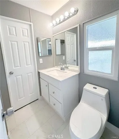 a white toilet sitting next to a shower