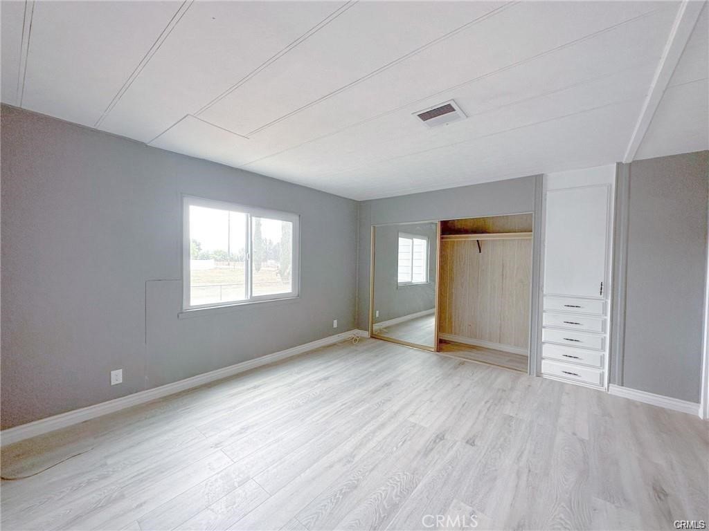 28160 Patterson Avenue Winchester, CA 92596 - Photo 35 of 57 an empty room with wooden floor and windows