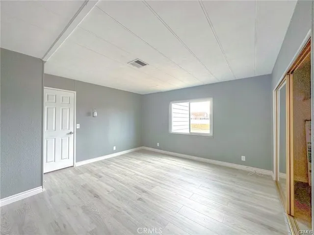 a view of an empty room and wooden floor