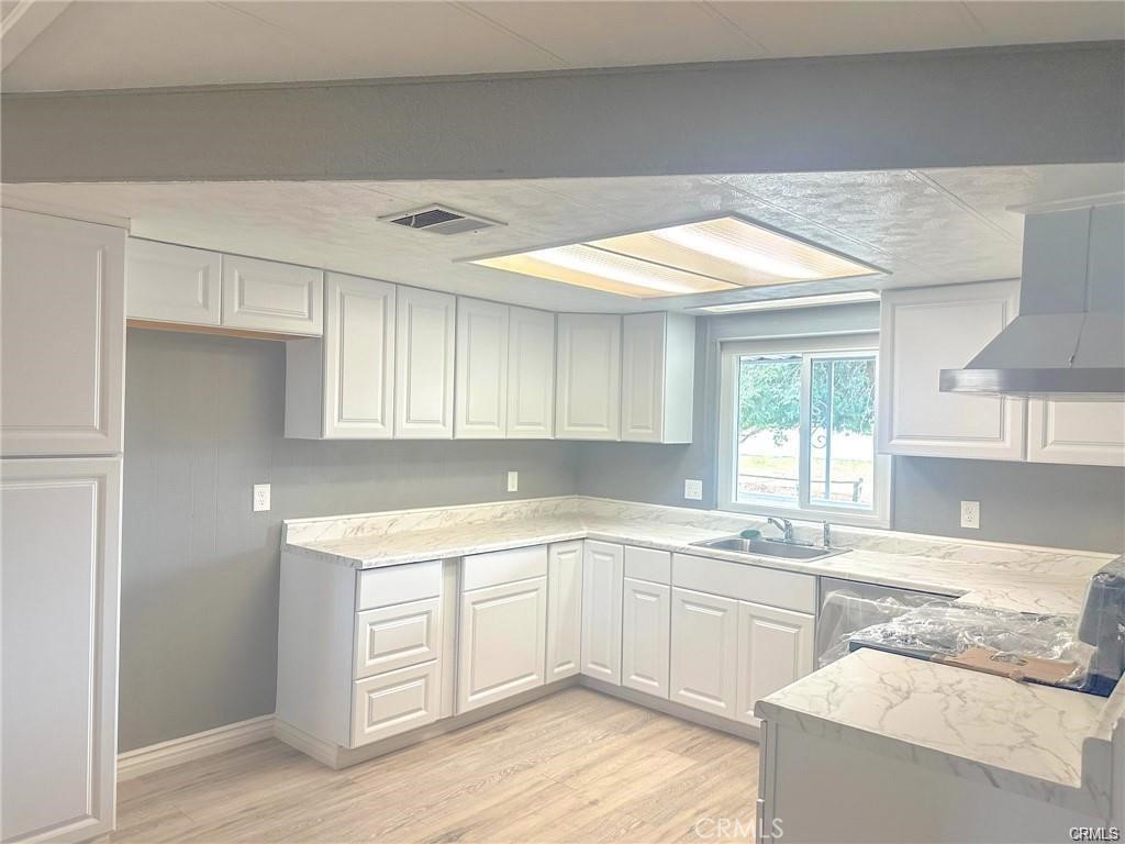 28160 Patterson Avenue Winchester, CA 92596 - Photo 44 of 57 a kitchen with a sink cabinets appliances and a window