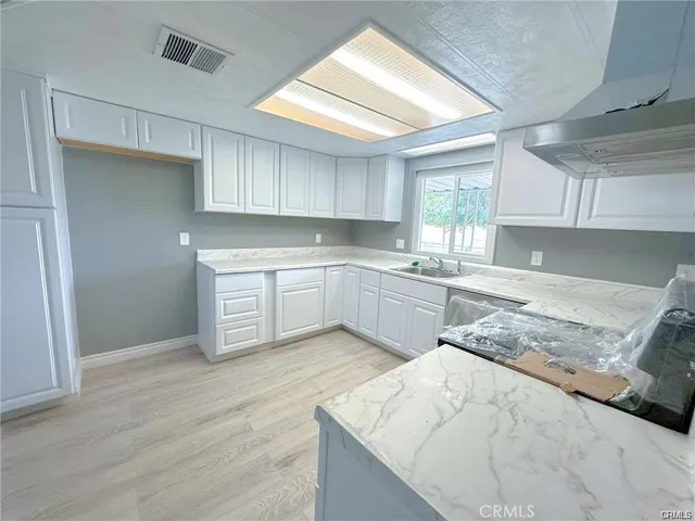 a view of a living room hardwood floor and a large window