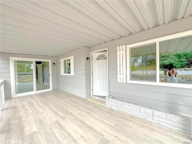 a view of a porch with wooden floor and outdoor space