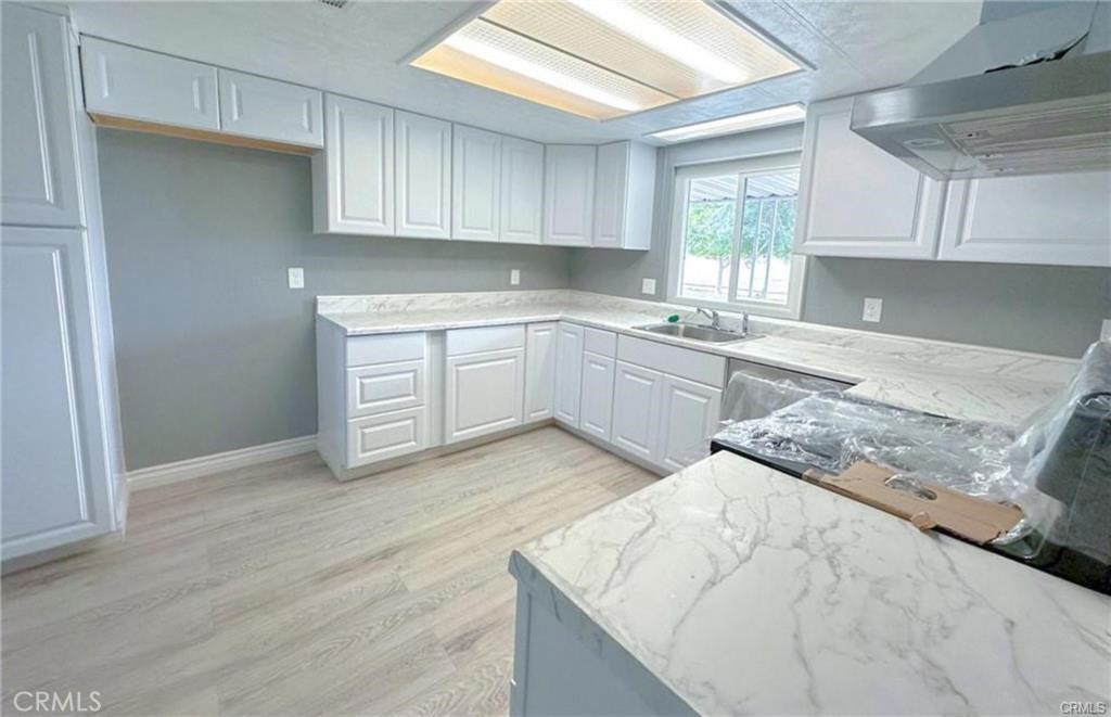 28160 Patterson Avenue Winchester, CA 92596 - Photo 56 of 57 a kitchen with granite countertop a sink and cabinets