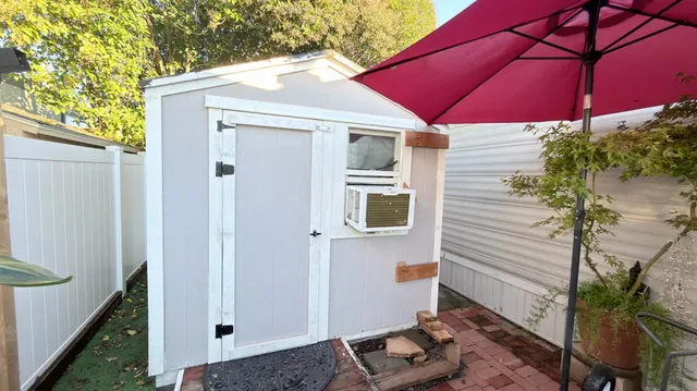 a view of a house with backyard and sitting area