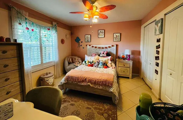 a bedroom with a bed dresser and a window