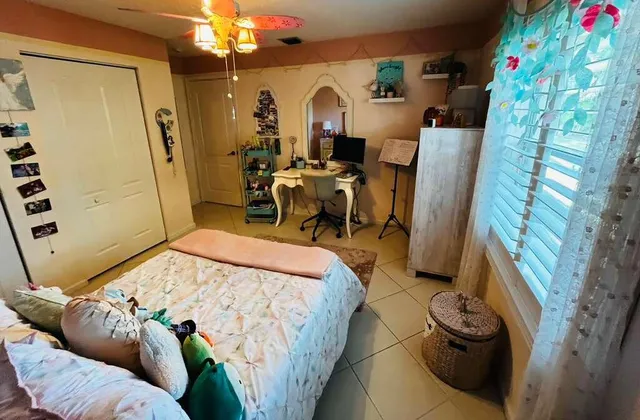 a bed room with a bed and a chair