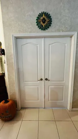 a room with a chair and a potted plant