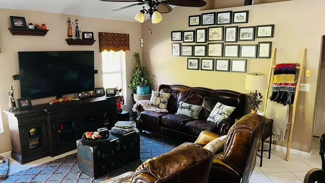 a living room with furniture a flat screen tv and a fireplace