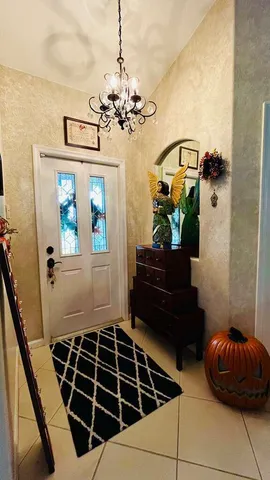a living room with a chandelier furniture and a window