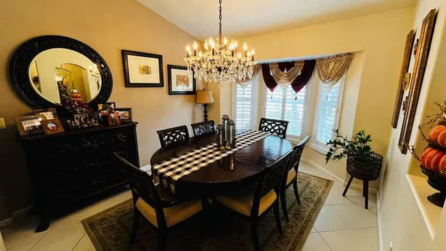 a view of a dining room with furniture and chandelier