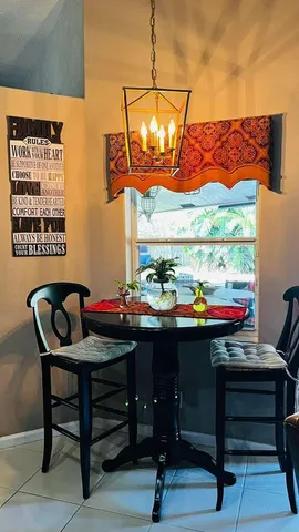 a room with a table chairs and a wooden floor