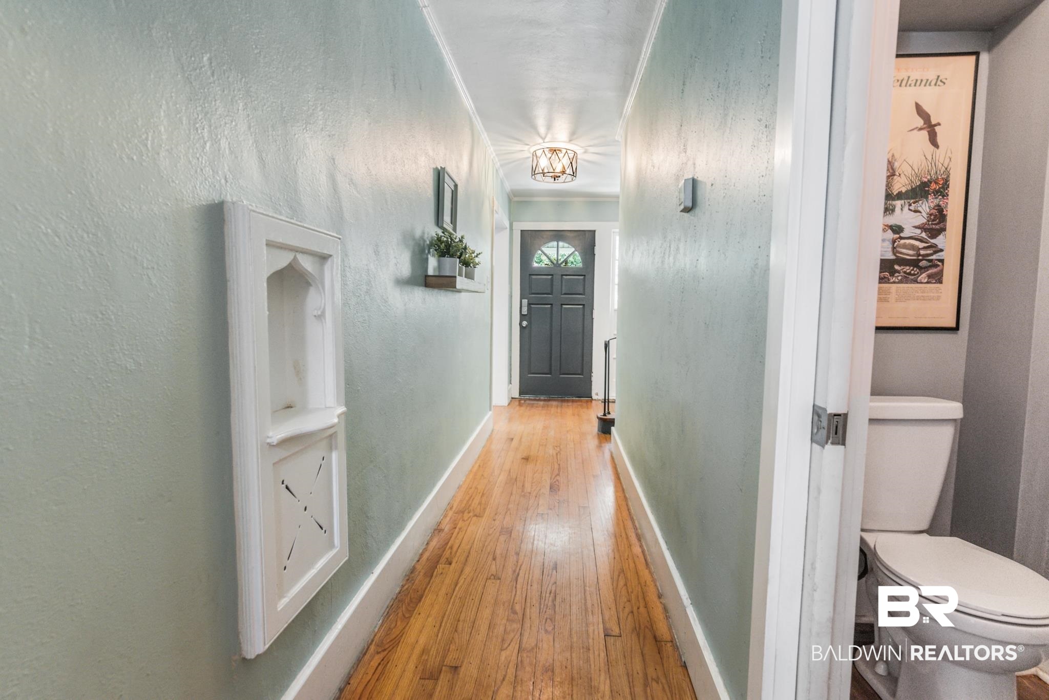 114 Crenshaw Street Mobile, AL 36606 - Photo 28 of 49 Hallway featuring light hardwood / wood-style flooring and ornamental molding