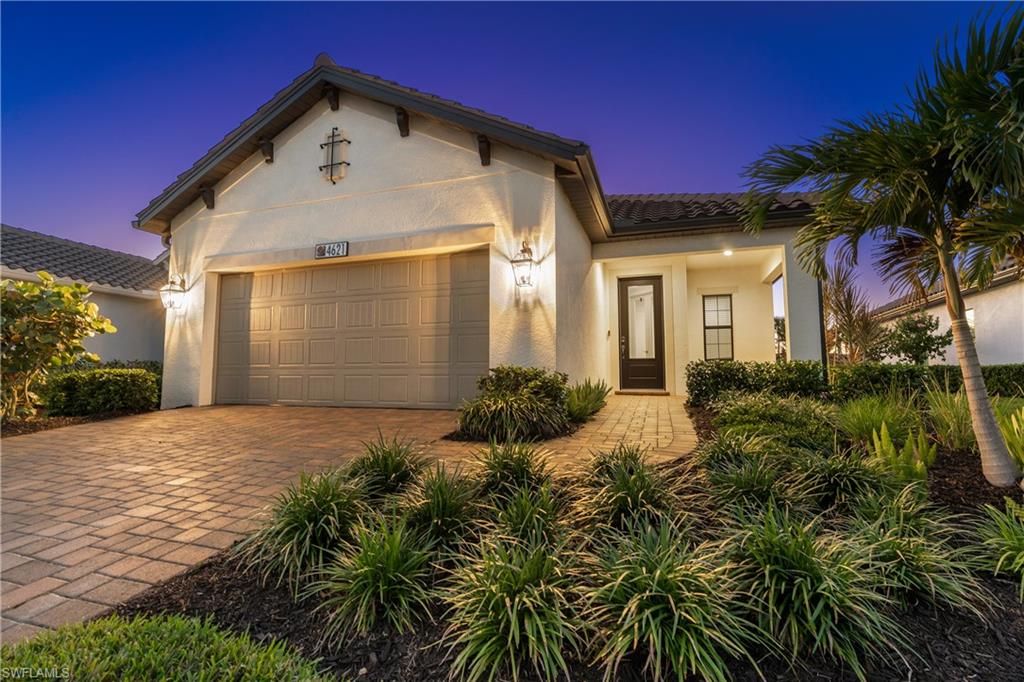4621 Centaurus Circle Naples, FL 34120 - Photo 12 of 47 Mediterranean / spanish-style home featuring a tiled roof, an attached garage, decorative driveway, and stucco siding
