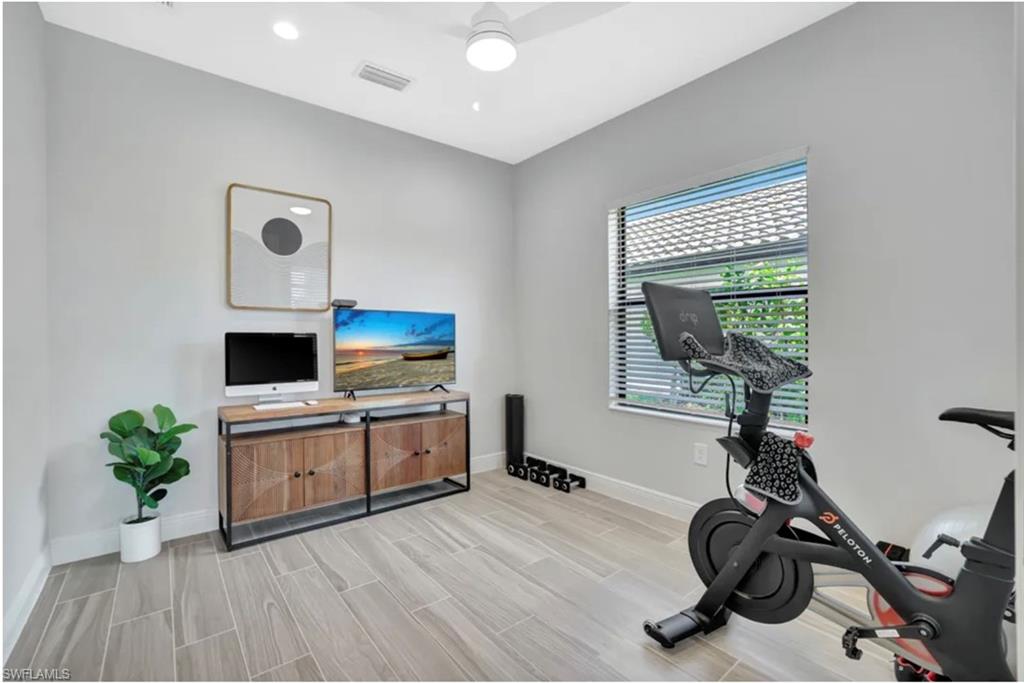 4621 Centaurus Circle Naples, FL 34120 - Photo 23 of 47 Exercise area with ceiling fan, wood tiled floors, and recessed lighting staged for photo