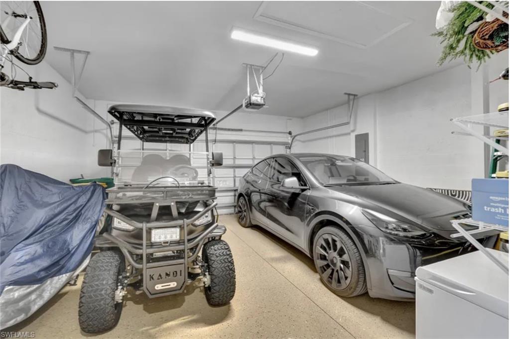 4621 Centaurus Circle Naples, FL 34120 - Photo 25 of 47 Garage featuring electric panel and owners vehicles