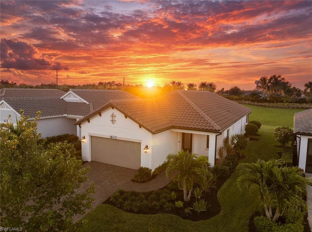 4621 Centaurus Circle Naples, FL 34120 - Photo 39 of 47 Mediterranean / spanish-style house featuring stucco siding, an attached garage, a tiled roof, and decorative driveway