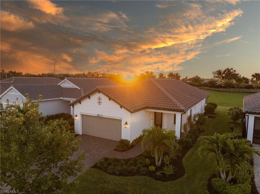 4621 Centaurus Circle Naples, FL 34120 - Photo 40 of 47 Mediterranean / spanish-style home with stucco siding, a tiled roof, an attached garage, and decorative driveway
