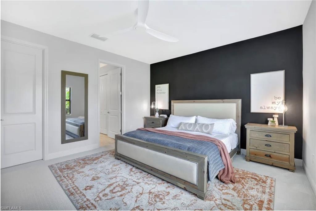 4621 Centaurus Circle Naples, FL 34120 - Photo 6 of 47 Carpeted bedroom with an accent wall and ceiling fan staged for photo