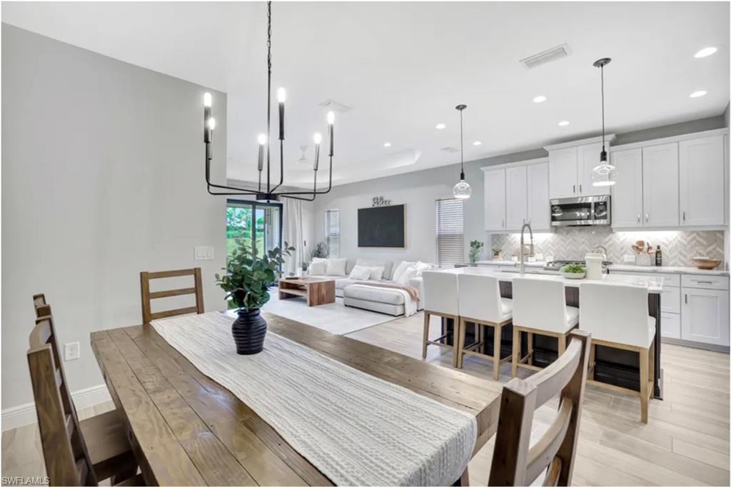 4621 Centaurus Circle Naples, FL 34120 - Photo 10 of 47 Dining room with recessed lighting and light wood-type tile staged for photo