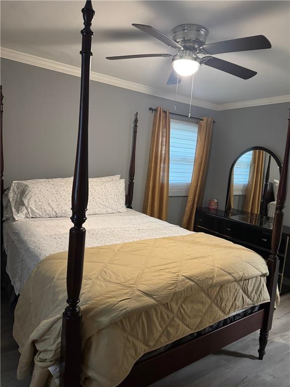 103 Wooten Drive Rome, GA 30165 - Photo 11 of 13 a bedroom with a bed and a chandelier