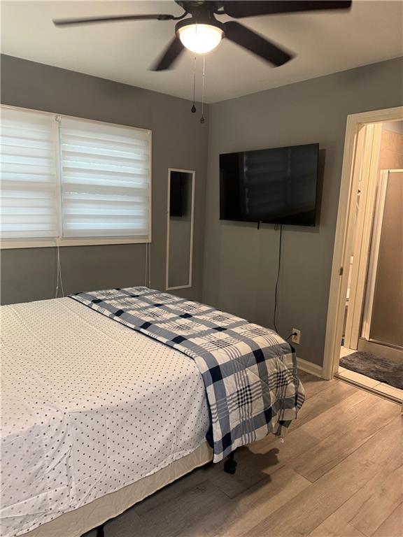 103 Wooten Drive Rome, GA 30165 - Photo 8 of 13 a bedroom with a large bed and a flat screen tv