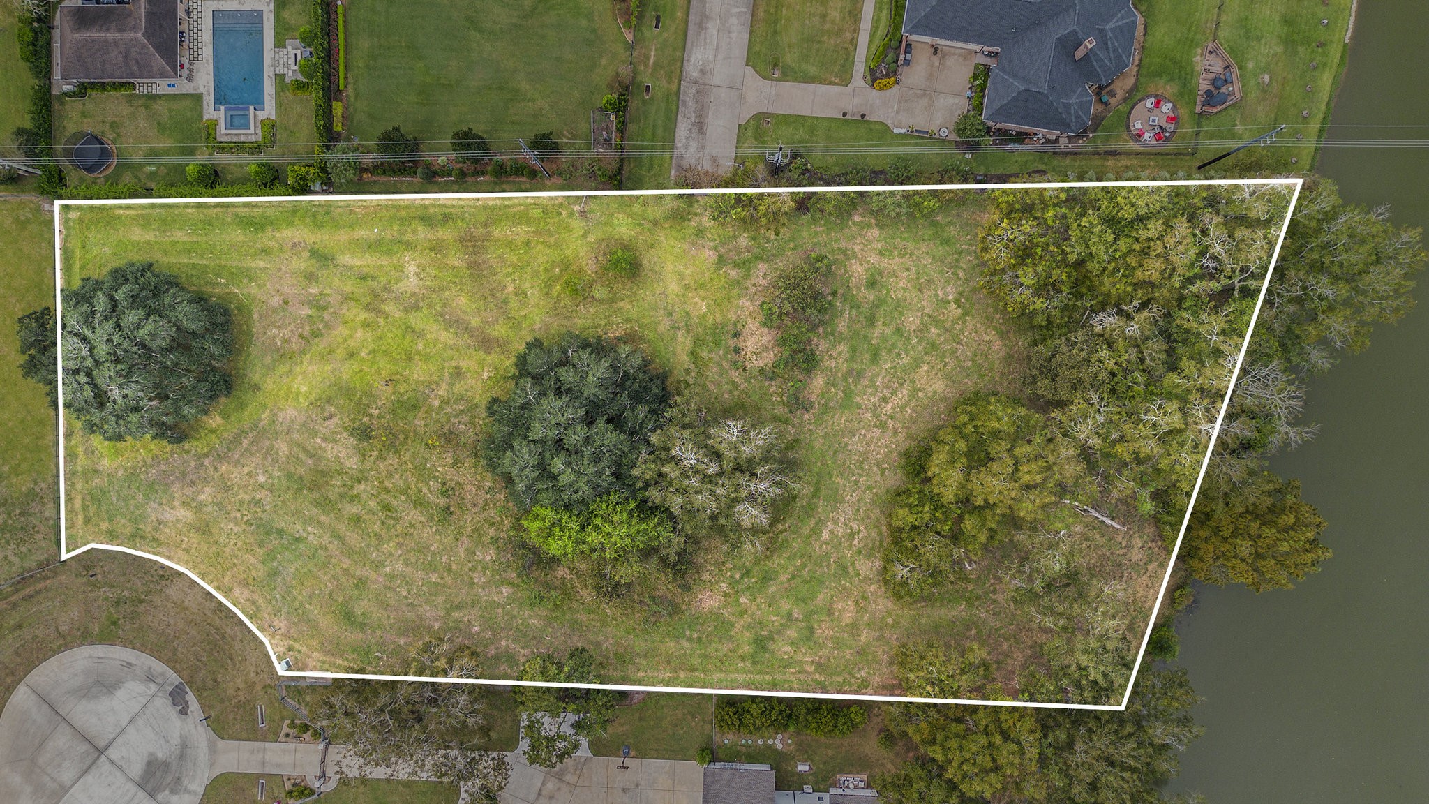 30703 Riverlake Road Fulshear, TX 77441 - Photo 2 of 15 a small pool with a tree in the background