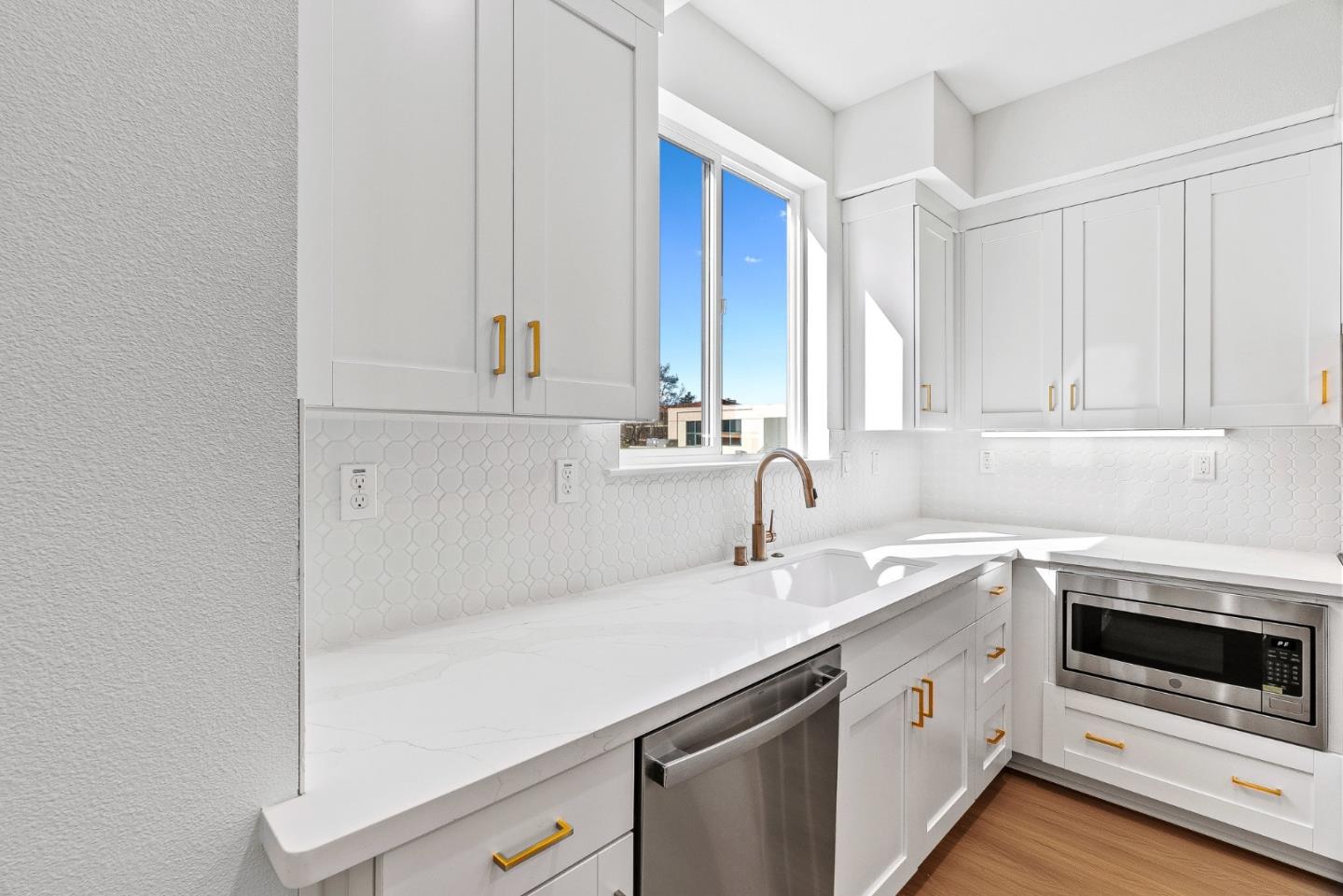 947 Woodside Road Redwood City, CA 94061 - Photo 11 of 51 a kitchen with a sink and cabinets