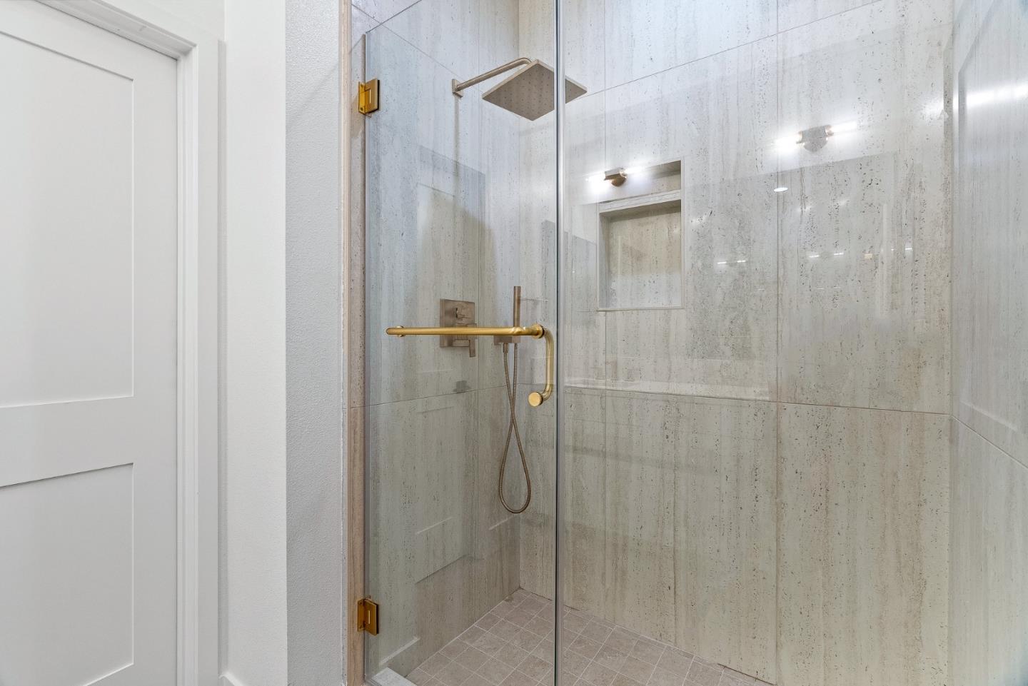 947 Woodside Road Redwood City, CA 94061 - Photo 16 of 51 a bathroom with a shower and a glass door