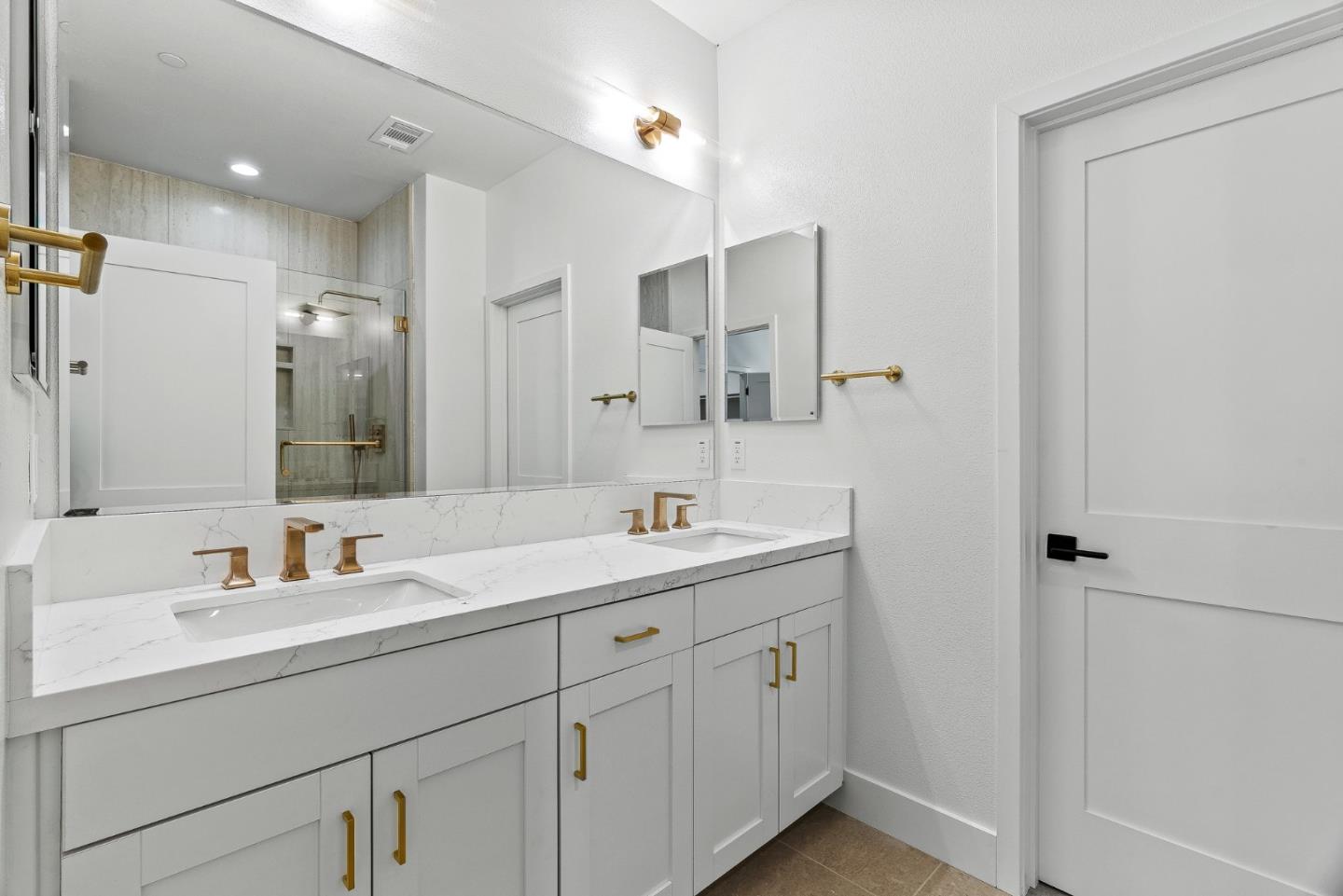 947 Woodside Road Redwood City, CA 94061 - Photo 17 of 51 a bathroom with a sink a large mirror and a shower