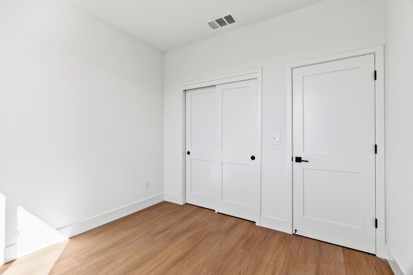 947 Woodside Road Redwood City, CA 94061 - Photo 20 of 51 a view of an empty room with closet and wooden floor