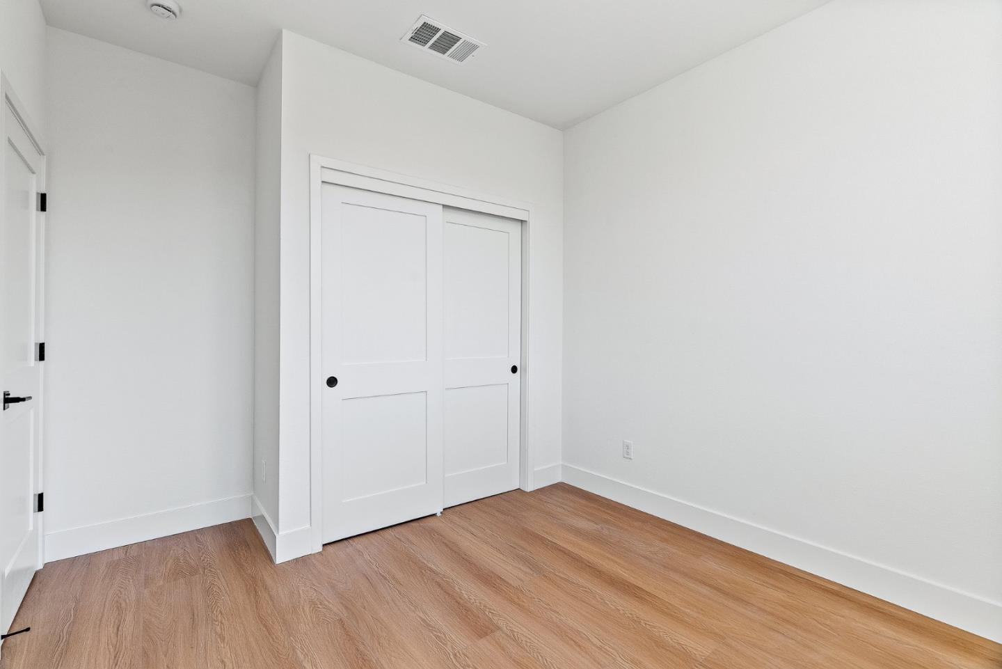 947 Woodside Road Redwood City, CA 94061 - Photo 22 of 51 a view of an empty room with wooden floor