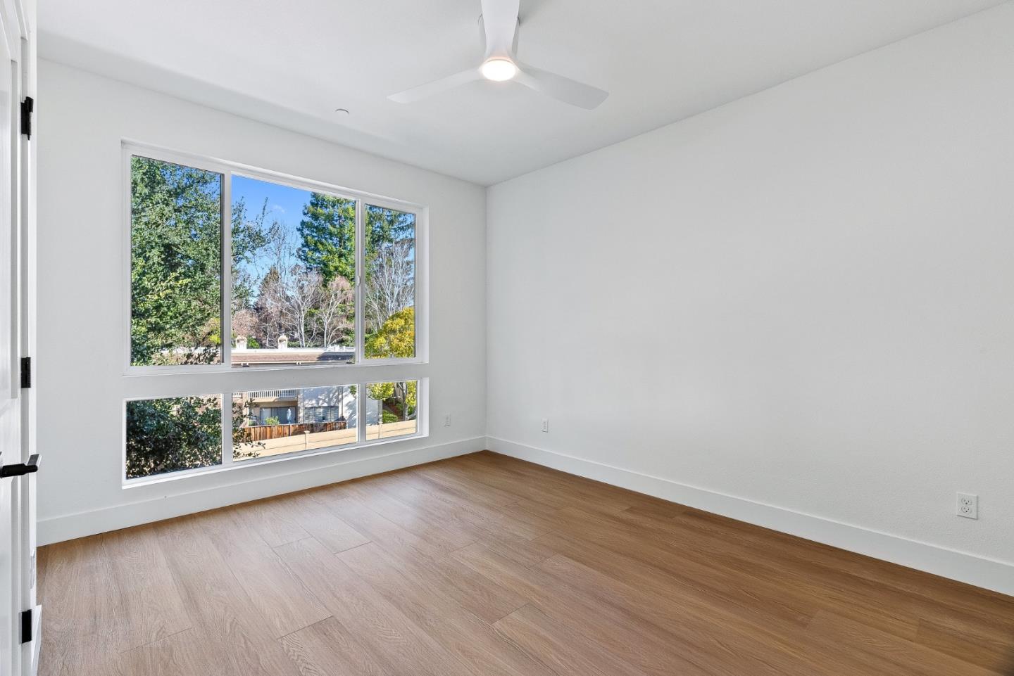 947 Woodside Road Redwood City, CA 94061 - Photo 23 of 51 an empty room with wooden floor and windows