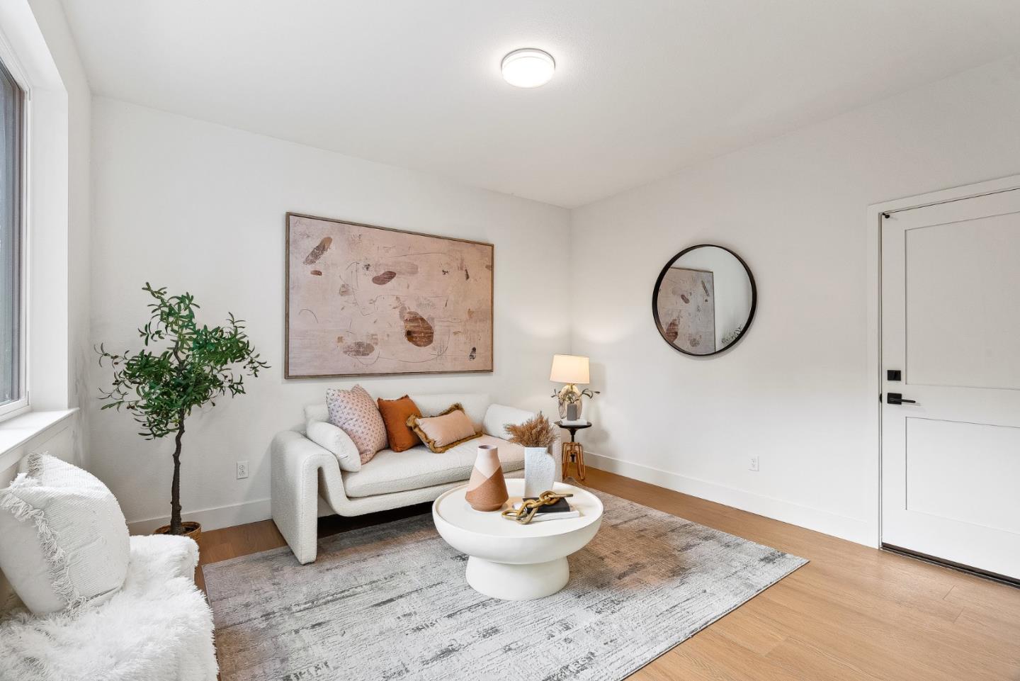 947 Woodside Road Redwood City, CA 94061 - Photo 27 of 51 a living room with furniture a mirror and a potted plant