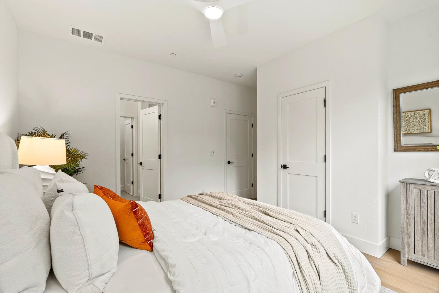 947 Woodside Road Redwood City, CA 94061 - Photo 44 of 51 a bedroom with a bed and a lamp